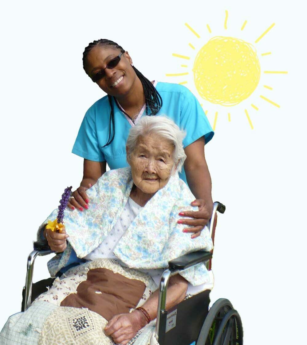 Caregiver with older woman in wheelchair